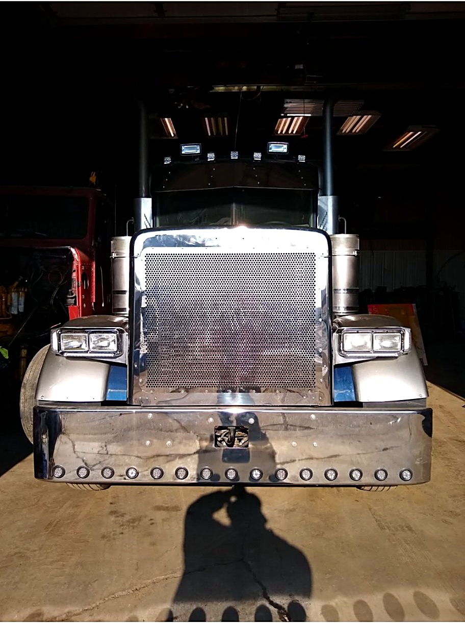 Head-on view of an ALR semi with a chrome grille in the shop