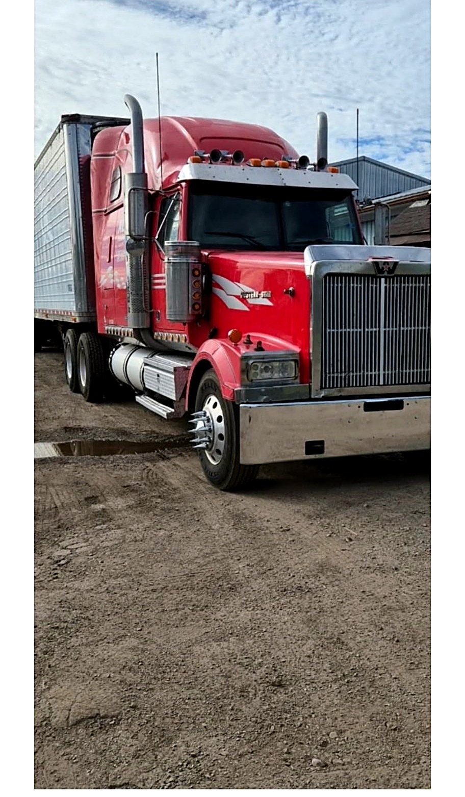 Red Western Star semi hooked to a silver trailer